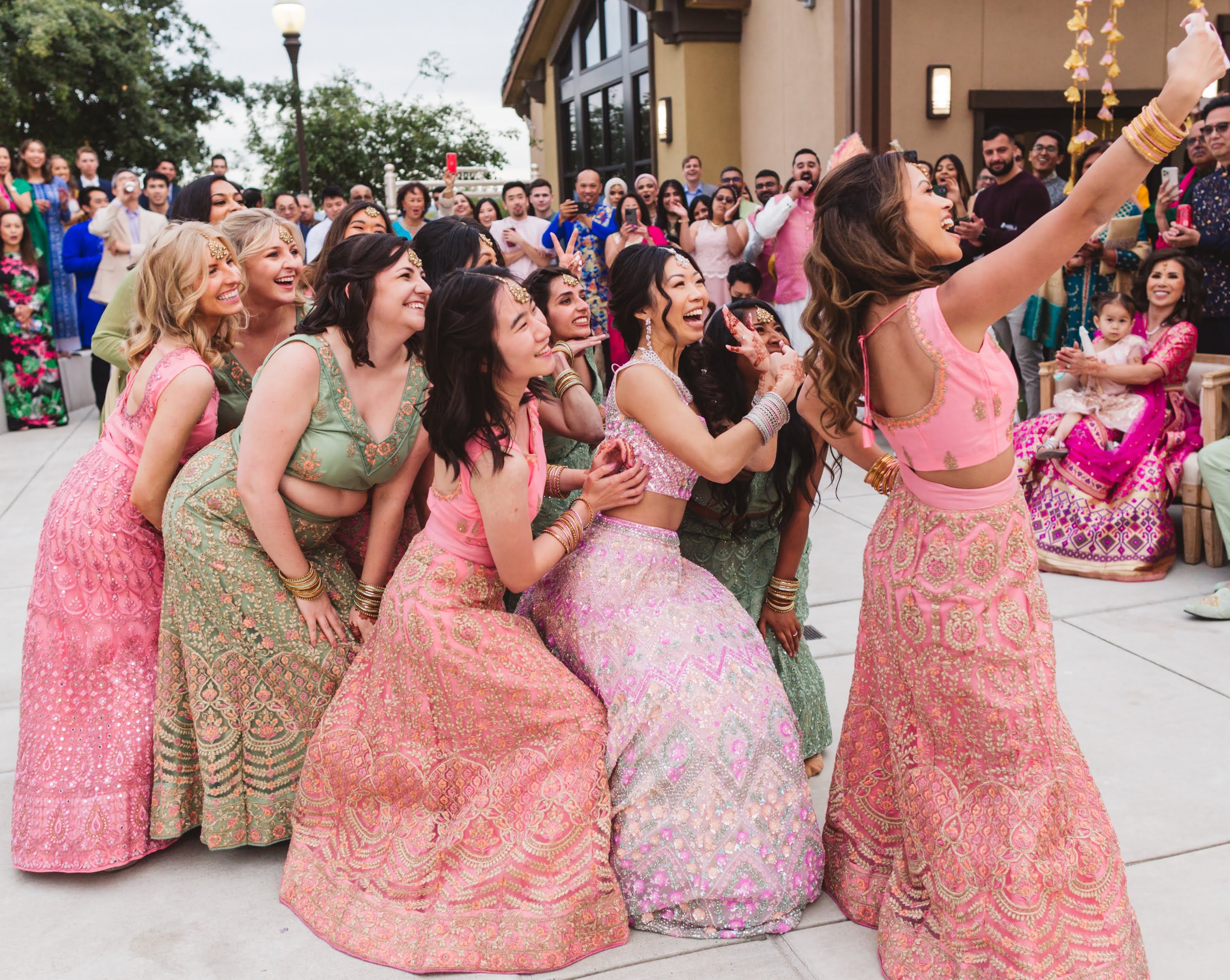 Bridesmaids in Inaayat lehengas taking a group selfie photo